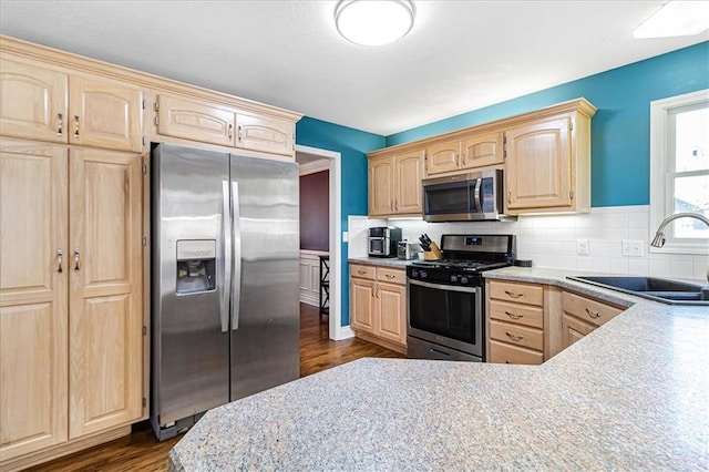 kitchen with dark hardwood / wood-style flooring, light brown cabinets, sink, and stainless steel appliances