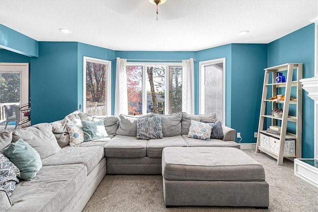 carpeted living room featuring ceiling fan