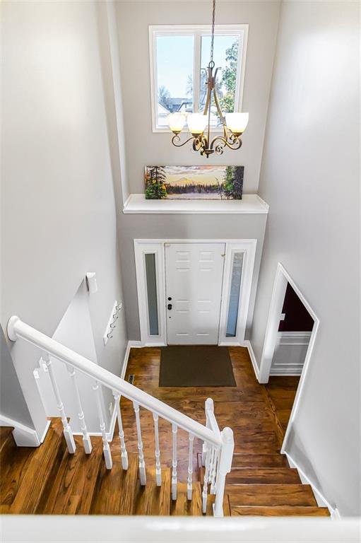 entryway featuring dark hardwood / wood-style flooring and a notable chandelier