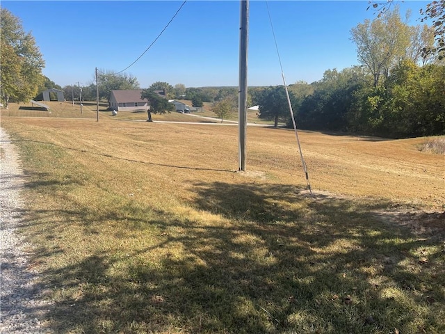 surrounding community featuring a yard and a rural view