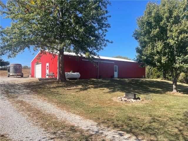 view of outbuilding featuring a yard and a garage