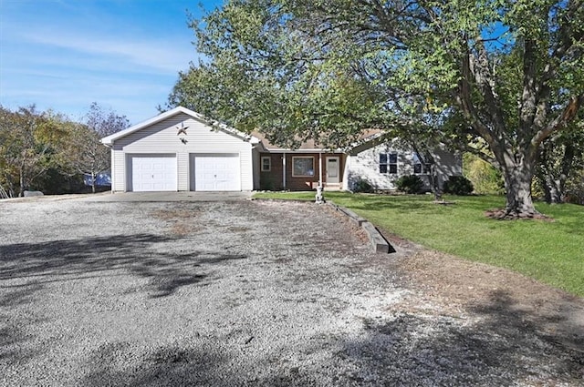 single story home with a front yard and a garage