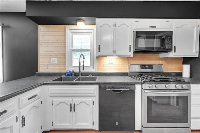 kitchen featuring sink, black appliances, white cabinetry, and tasteful backsplash