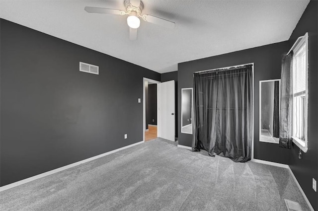 unfurnished bedroom with light carpet and ceiling fan