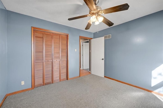 unfurnished bedroom featuring a closet, carpet, and ceiling fan