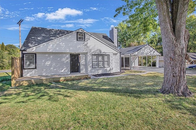 rear view of property featuring a patio area and a yard