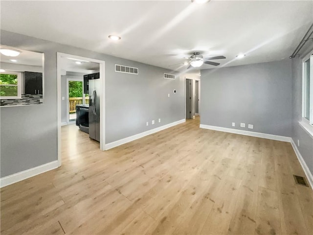 spare room with light wood-type flooring and ceiling fan