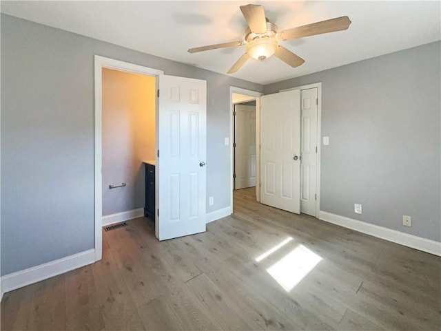 unfurnished bedroom with light hardwood / wood-style floors, a closet, and ceiling fan