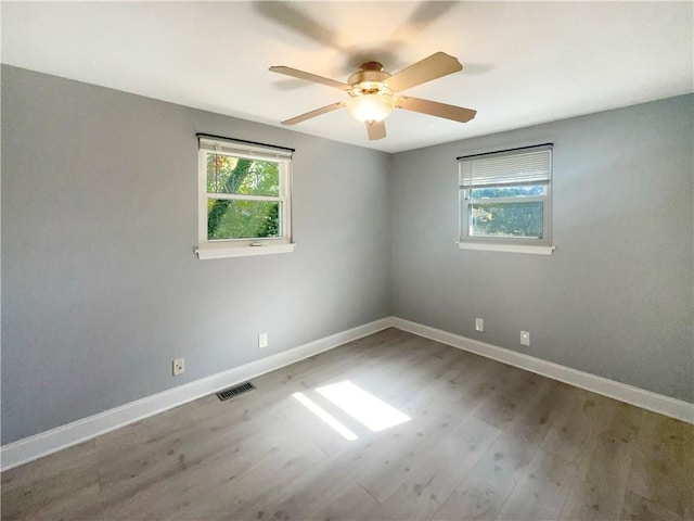 spare room with wood-type flooring and ceiling fan