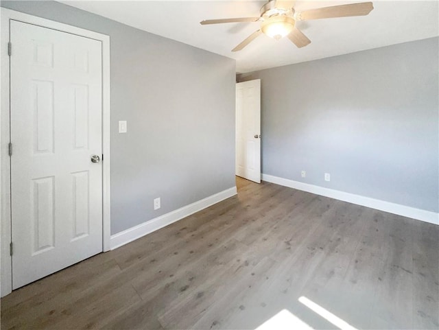 empty room featuring hardwood / wood-style floors and ceiling fan