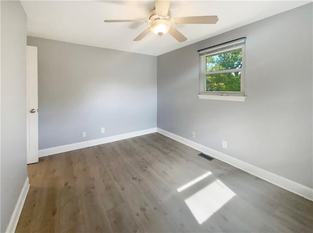 empty room with hardwood / wood-style flooring and ceiling fan