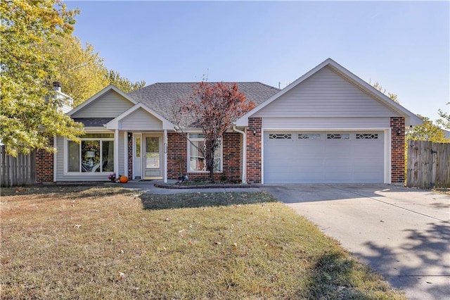 view of front of property featuring a front yard and a garage