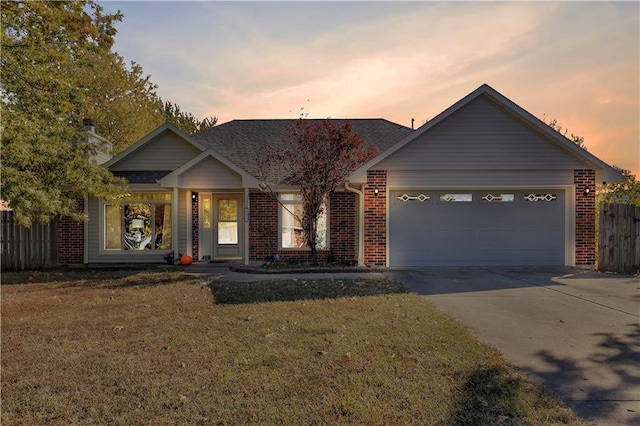 view of front of property with a yard and a garage