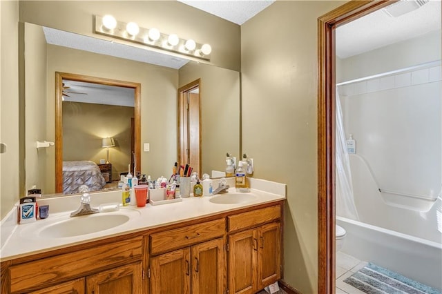 full bathroom with toilet, shower / bath combo, vanity, and tile patterned flooring