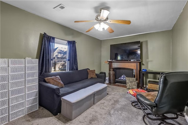 living room with ceiling fan and carpet flooring