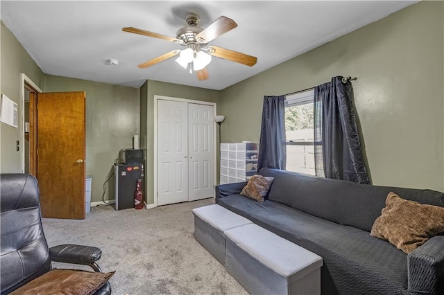 living room featuring ceiling fan and light colored carpet