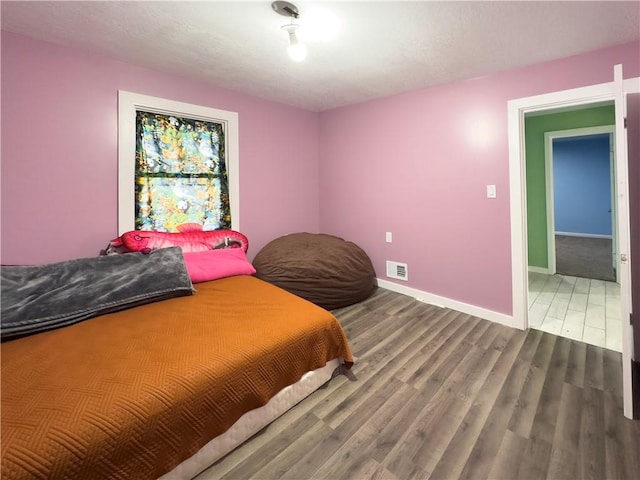 bedroom with wood-type flooring