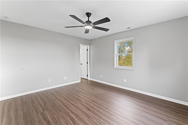 empty room featuring dark hardwood / wood-style floors and ceiling fan