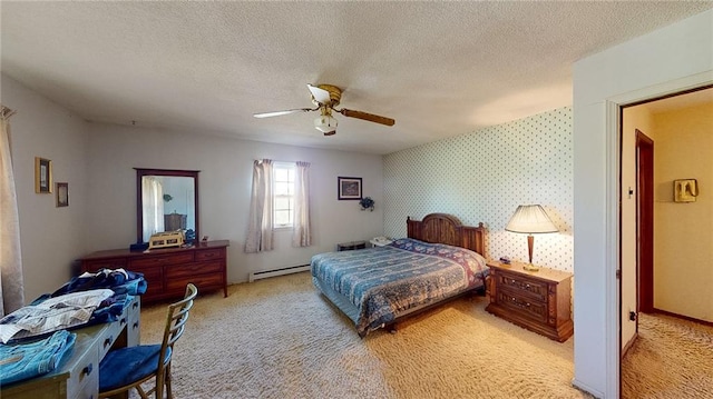 carpeted bedroom with a textured ceiling, a baseboard heating unit, and ceiling fan