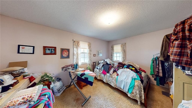 carpeted bedroom with a textured ceiling