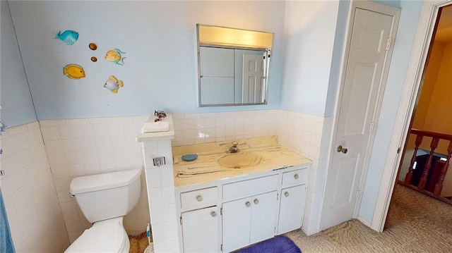 bathroom featuring vanity, toilet, tile patterned floors, and tile walls