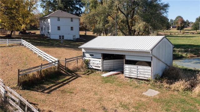 view of yard with a rural view and an outdoor structure