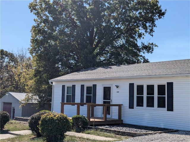 view of front facade with a deck and a storage unit