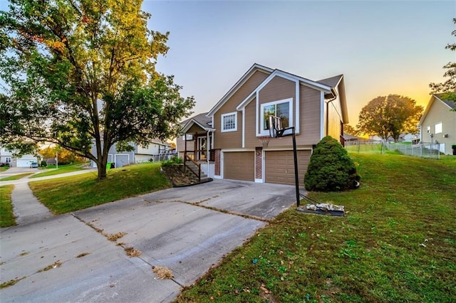 view of front of property featuring a yard and a garage