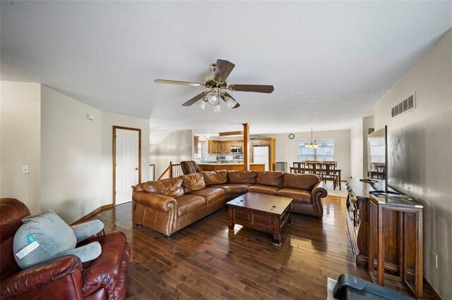 1116 N Mohican Ct, Independence, MO 64056 - living room with dark wood-style floors, ceiling fan, and a chandelier