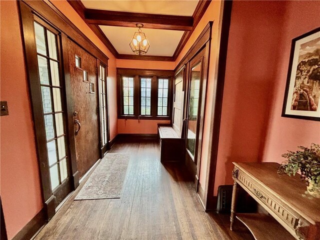 421 W Thompson St, Maryville, MO 64468 - doorway to outside featuring crown molding, a notable chandelier, dark wood finished floors, and baseboards