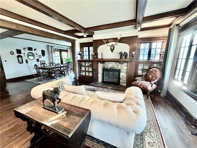 421 W Thompson St, Maryville, MO 64468 - living room with wood finished floors, coffered ceiling, beamed ceiling, a stone fireplace, and baseboards