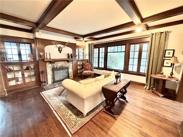 421 W Thompson St, Maryville, MO 64468 - living area with beamed ceiling, plenty of natural light, wood finished floors, and a fireplace