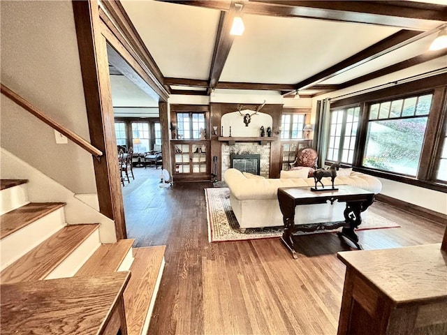 421 W Thompson St, Maryville, MO 64468 - living area featuring stairway, coffered ceiling, beam ceiling, a fireplace, and wood finished floors