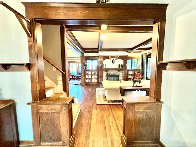 421 W Thompson St, Maryville, MO 64468 - living room featuring stairs, a stone fireplace, wood finished floors, and a healthy amount of sunlight