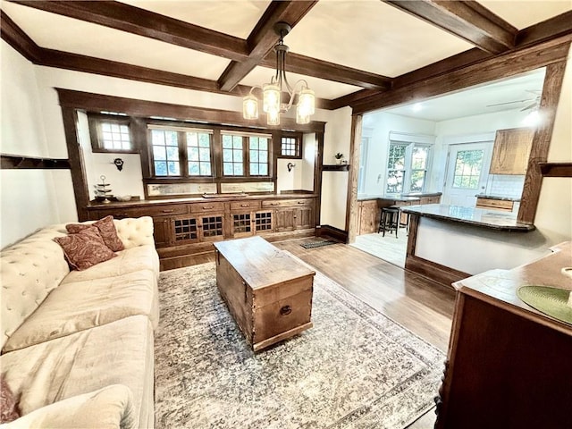 421 W Thompson St, Maryville, MO 64468 - living room featuring wood finished floors, an inviting chandelier, beamed ceiling, and coffered ceiling