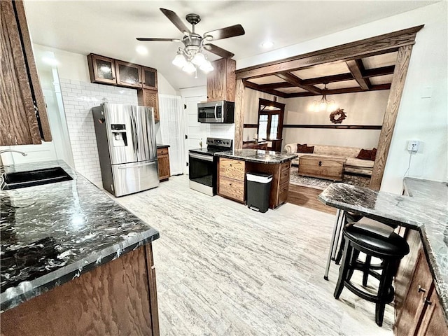 421 W Thompson St, Maryville, MO 64468 - kitchen featuring a sink, appliances with stainless steel finishes, open floor plan, light wood-type flooring, and a ceiling fan