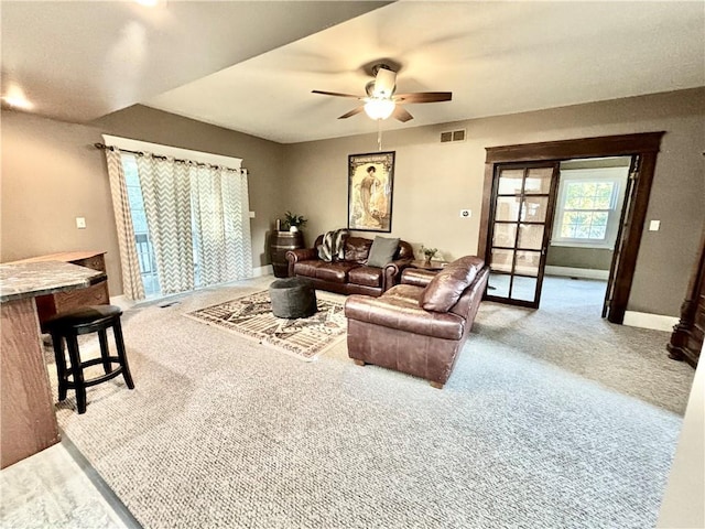 421 W Thompson St, Maryville, MO 64468 - carpeted living room with baseboards, visible vents, and a ceiling fan