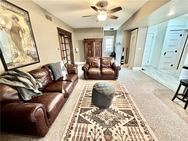421 W Thompson St, Maryville, MO 64468 - carpeted living area with baseboards, visible vents, and a ceiling fan
