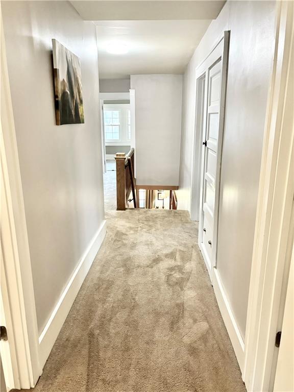 421 W Thompson St, Maryville, MO 64468 - corridor featuring an upstairs landing, baseboards, and carpet floors