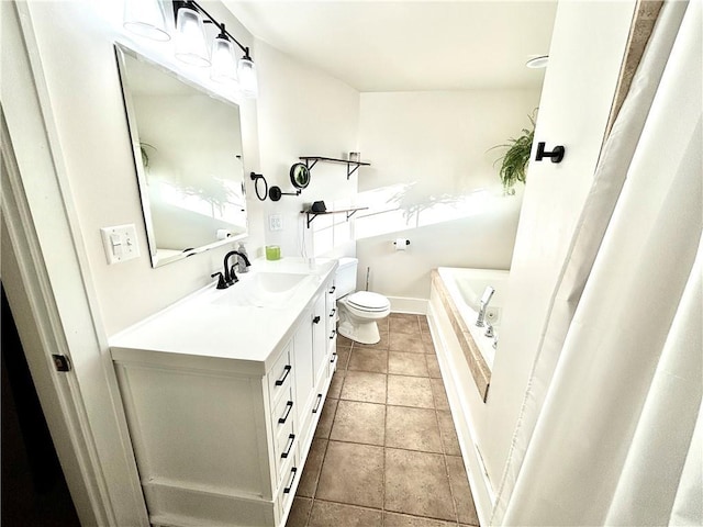 421 W Thompson St, Maryville, MO 64468 - full bathroom with vanity, a bathtub, toilet, baseboards, and tile patterned flooring