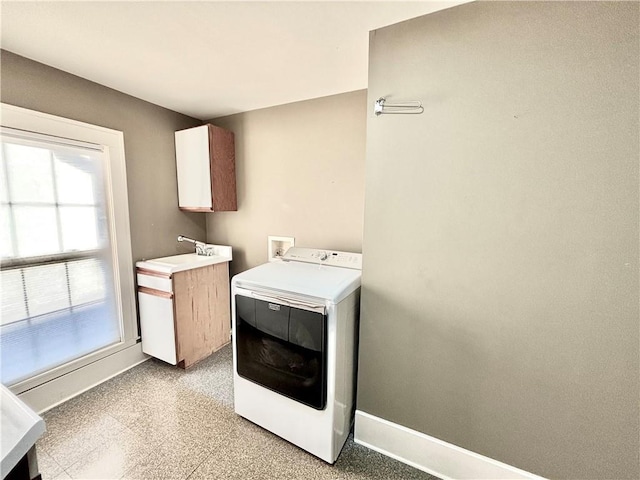 421 W Thompson St, Maryville, MO 64468 - washroom with baseboards, washer / dryer, cabinet space, and a sink