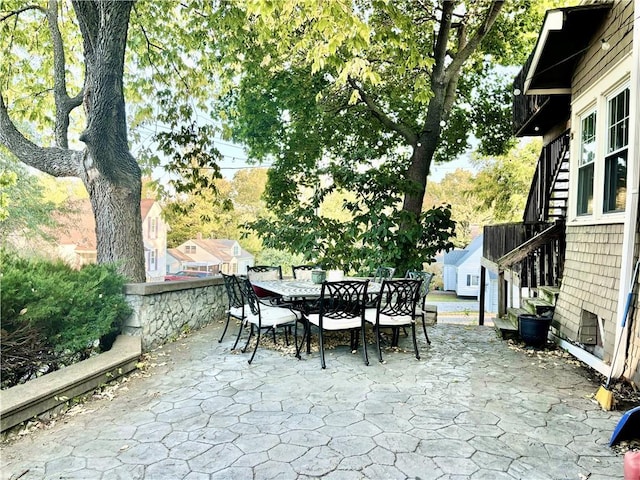 421 W Thompson St, Maryville, MO 64468 - view of patio featuring outdoor dining area and stairway