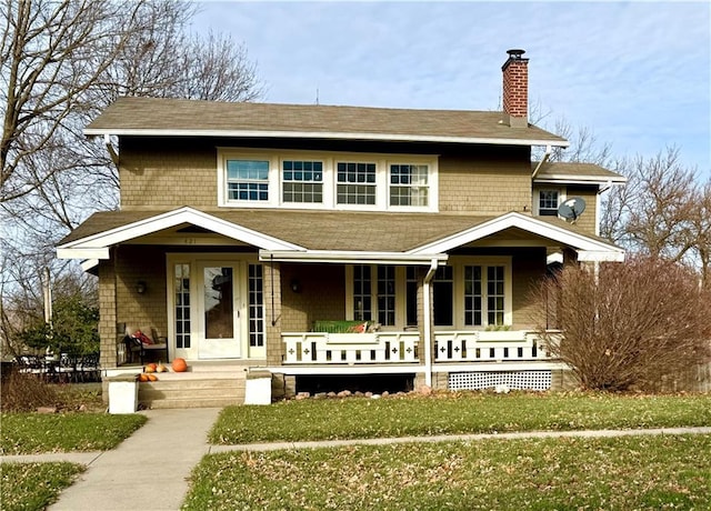 view of front of home with a front yard and a porch