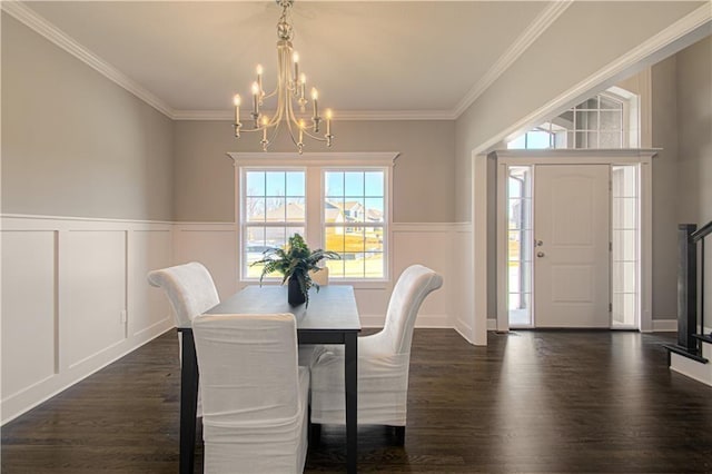 dining space with crown molding, a notable chandelier, and dark hardwood / wood-style flooring