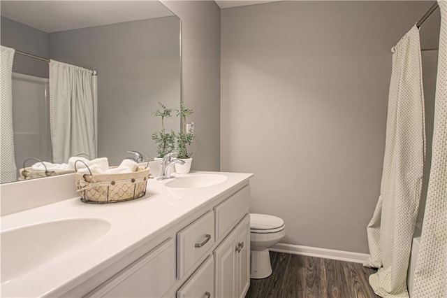 bathroom with vanity, wood-type flooring, and toilet