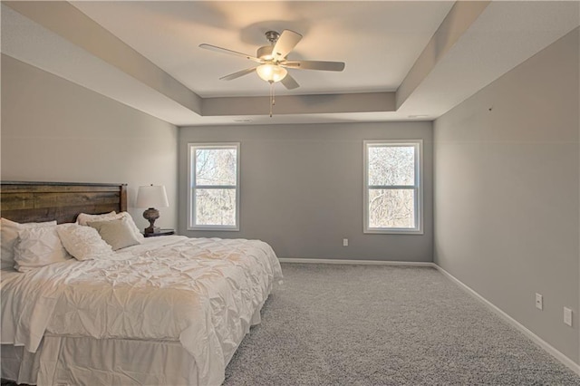 bedroom with ceiling fan, carpet flooring, and multiple windows