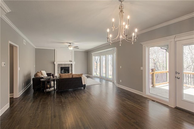 living room featuring ornamental molding, a wealth of natural light, a tile fireplace, and dark hardwood / wood-style flooring