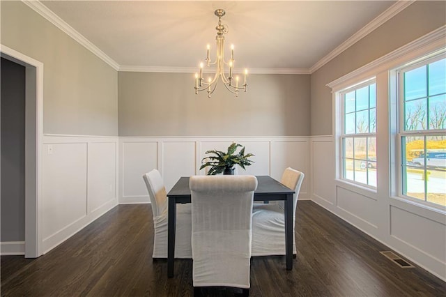 dining space featuring ornamental molding, dark hardwood / wood-style floors, and a chandelier