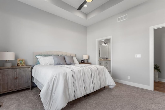 carpeted bedroom featuring ensuite bath and ceiling fan