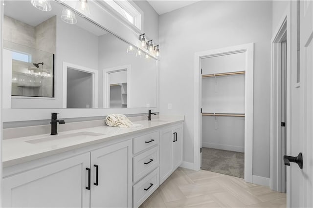 bathroom featuring a shower and vanity